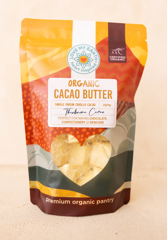 Bag of organic cacao butter with a visible brand logo on a beige background